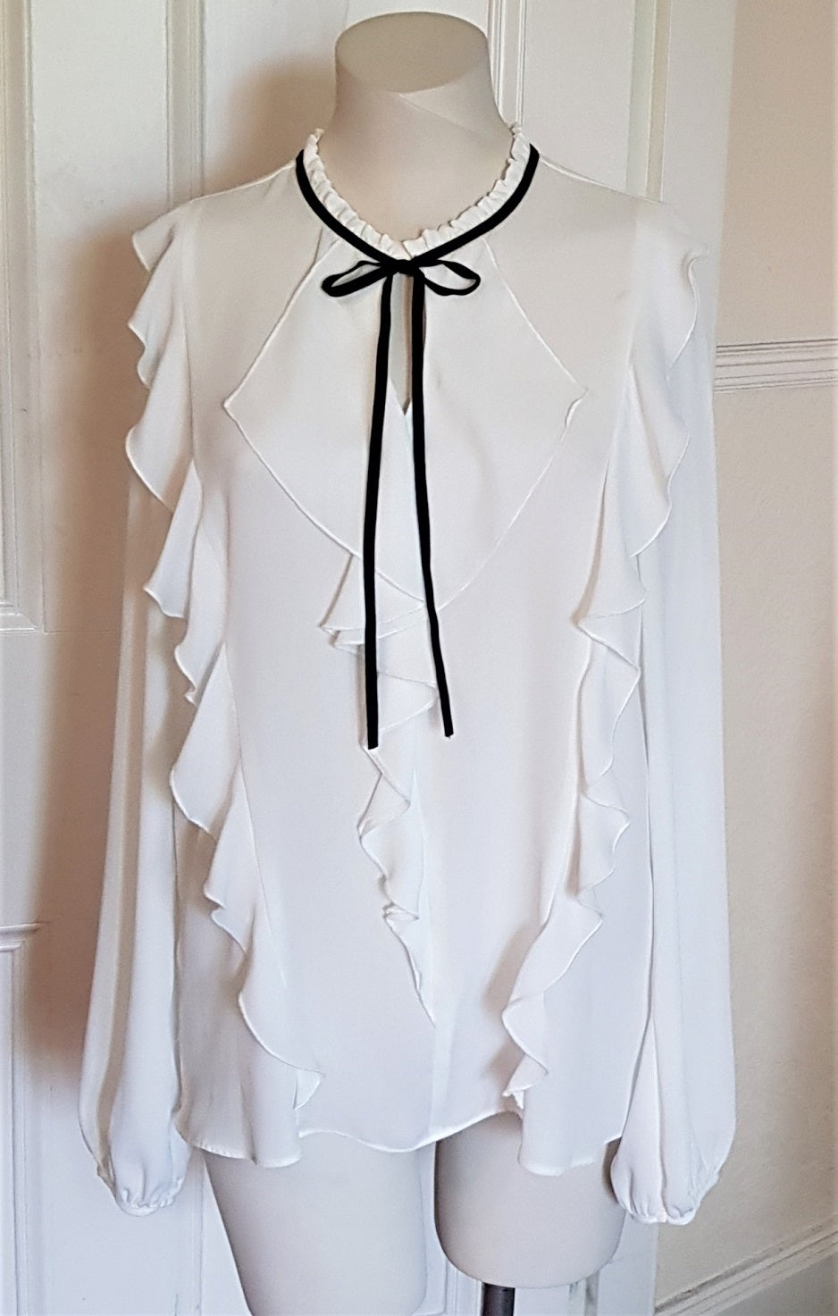 white ruffle blouse with black tie